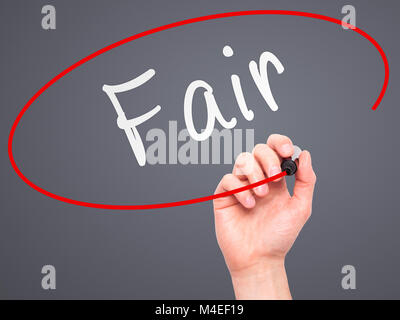 Man Hand writing Fair black with marker on visual screen Stock Photo