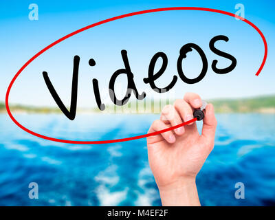 Man Hand writing Videos with black marker on visual screen. Isolated on ...