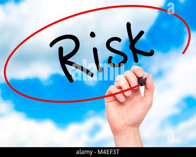 Man Hand writing Risk with black marker on visual screen Stock Photo