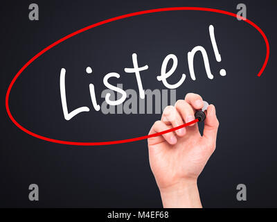 Man Hand writing Listen with black marker on visual screen Stock Photo
