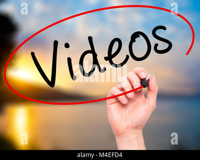Man Hand writing Videos with black marker on visual screen. Isolated on ...