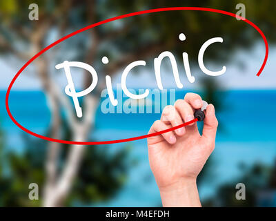 Man Hand writing Picnic with black marker on visual screen Stock Photo