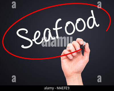 Man Hand writing Seafood with black marker on visual screen Stock Photo