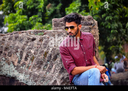 Young man with checked shirt and sun glasses, Pune, Maharashtra. Stock Photo