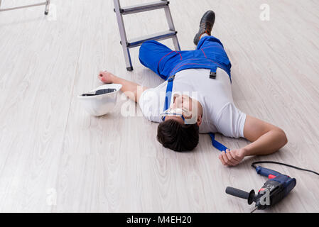 Worker after falling from height - unsafe behavior Stock Photo