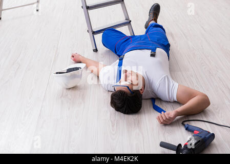 Worker after falling from height - unsafe behavior Stock Photo