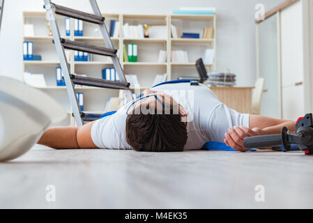 Worker after falling from height - unsafe behavior Stock Photo