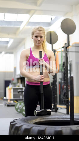 woman with hammer in gym Stock Photo