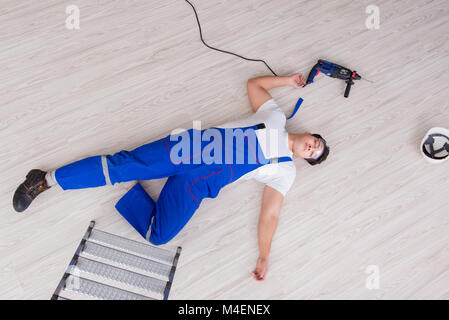 Worker after falling from height - unsafe behavior Stock Photo