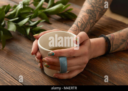 Female hands holding coffee cup Stock Photo
