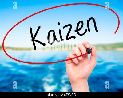 Man Hand writing Kaizen with black marker on visual screen Stock Photo