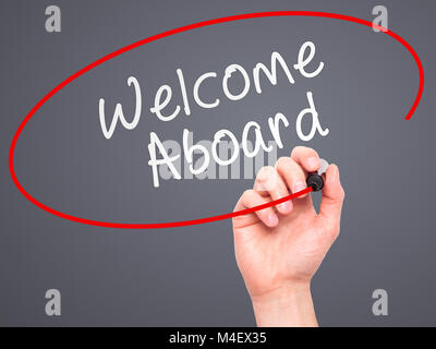 Man hand writing Welcome Aboard on visual screen Stock Photo