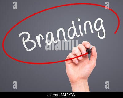 Man Hand writing Branding with marker on transparent wipe board Stock Photo