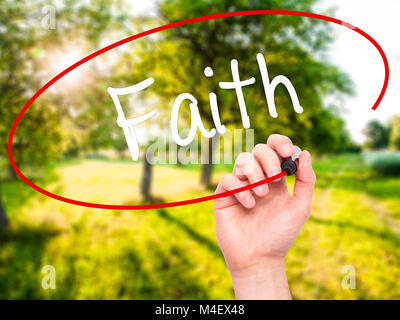 Man Hand writing Faith with black marker on visual screen Stock Photo