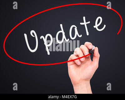 Man Hand writing Update with marker on transparent wipe board Stock Photo