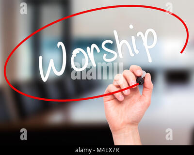 Man Hand writing Worship with black marker on visual screen Stock Photo