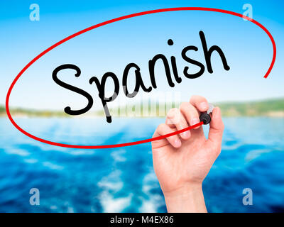 Man Hand writing Spanish with black marker on visual screen Stock Photo