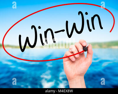 Man Hand writing Win-Win with black marker on visual screen. Stock Photo