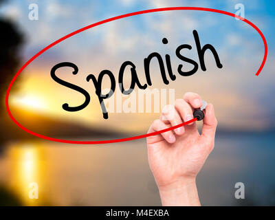 Man Hand writing Spanish with black marker on visual screen Stock Photo