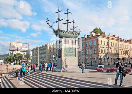 SAINT-PETERSBURG, RUSSIA - AUGUST 27, 2015: Chinese tourists near the Russian ship of the line Poltava (1712) Sculpture on the Neva River Embankment Stock Photo