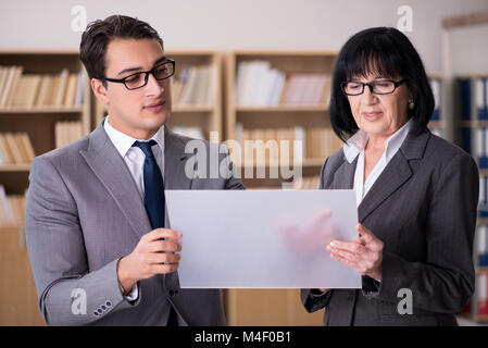 Business couple discussing business results on tablet Stock Photo