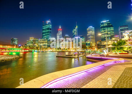 Perth, Australia - Jan 5, 2018: walkway with night lighting at Elizabeth Quay marina and buildings of Central business district reflecting on Swan River, Perth Downtown, Western Australia. Night scene Stock Photo