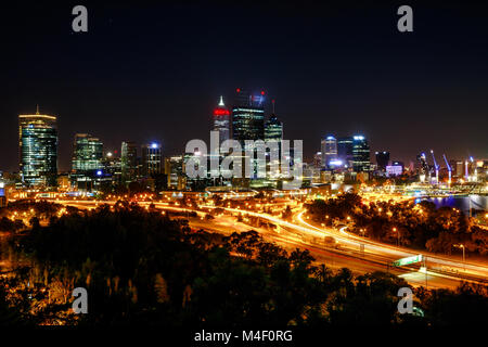 Panoramic view from King's Park near War Memorial of Perth Skyline with skyscrapers and light trails of traffic and Swan River. This overlooks is a famous landmark in Perth, Western Australia.