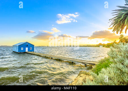 Blue Boat House: the iconic and most photographed Perth landmark in Western Australia. Scenic sunset landscape on the Swan River. Boathause with wooden jetty and copy space.