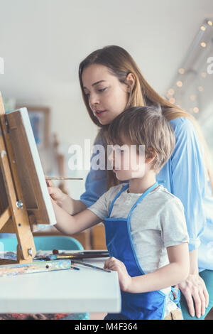 Teacher and pupil in the art workshop Stock Photo