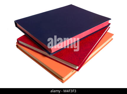 A blue, a red and an orange book against a white background Stock Photo