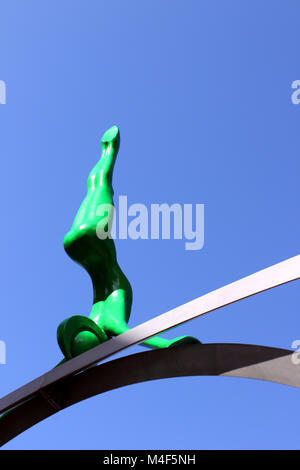 Upright view of green Spofforth sculpted figure against deep blue sky Stock Photo