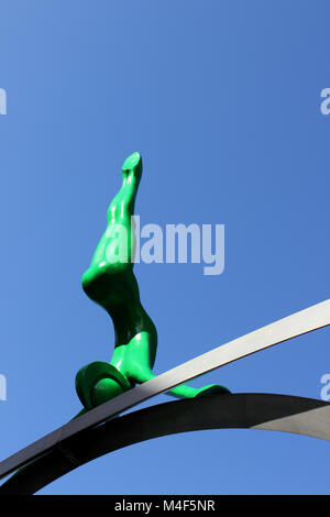 Upright view of green Spofforth sculpted figure against deep blue sky Stock Photo