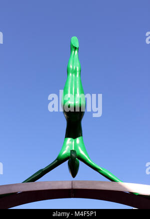 Upright view of green Spofforth sculpted figure against deep blue sky Stock Photo