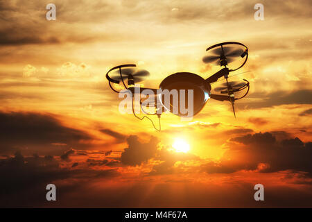 Drone flying at sunset. Sun shining on dramatic sky. Stock Photo
