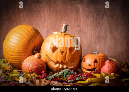 Halloween pumpkins, carved jack-o-lantern in fall leaves Stock Photo