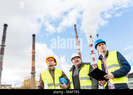 Construction engineers examining thermoelectric power station. Stock Photo