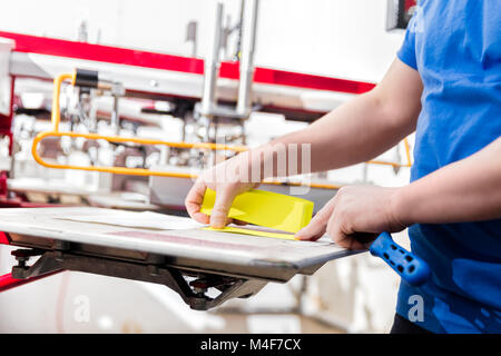Man preparing fabric for screen printing. Stock Photo