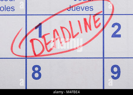 Close-up Of Word Deadline Written On A Calendar Date Stock Photo