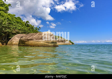 Deserted and unspoilt beach with forest Stock Photo