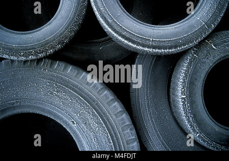 Old heap of tires , tyres outside with frost on them Stock Photo