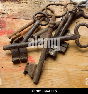 Antique keys on wooden table Stock Photo