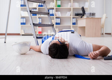 Worker after falling from height - unsafe behavior Stock Photo