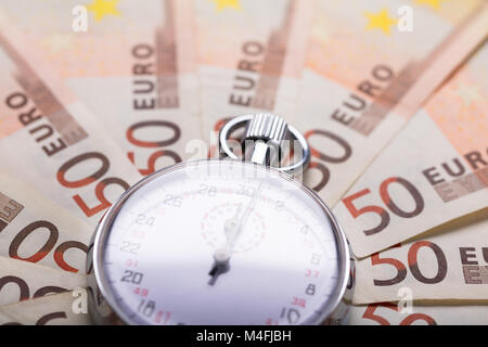 High Angle View Of A Stopwatch On Euro Notes Stock Photo