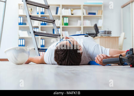 Worker after falling from height - unsafe behavior Stock Photo