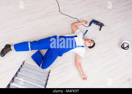 Worker after falling from height - unsafe behavior Stock Photo