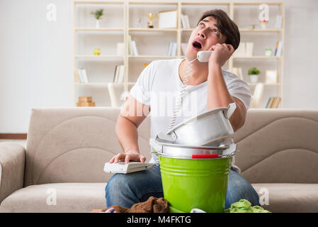 Man at home dealing with neighbor flood leak Stock Photo