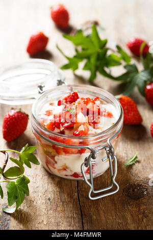 Homemade layered strawberry dessert in a jar