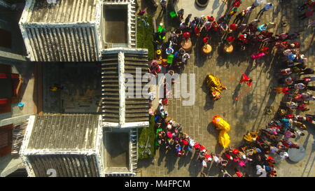 Qionghai, China's Hainan Province. 16th Feb, 2018. People watch performance at the Dayuan Ancient Town of Qionghai City, south China's Hainan Province, Feb. 16, 2018. People held different activities to celebrate Chinese Lunar New Year all over China. Credit: Meng Zhongde/Xinhua/Alamy Live News Stock Photo