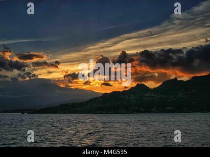 Giardini Naxos, Sicily, Italy. 12th Oct, 2004. A brilliant sunset spills through the dramatic clouds over the resort town of Giardini Naxos, Sicily, on the Ionian Sea. Sicily has become a popular tourist destination. Credit: Arnold Drapkin/ZUMA Wire/Alamy Live News Stock Photo