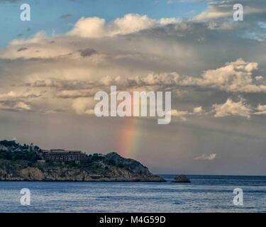 Giardini Naxos, Sicily, Italy. 12th Oct, 2004. A rainbow is visible over the Ionian Sea near the resort town of Giardini Naxos, Sicily. Sicily has become a popular tourist destination. Credit: Arnold Drapkin/ZUMA Wire/Alamy Live News Stock Photo